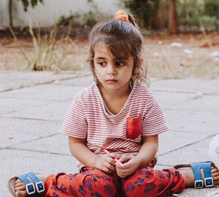 et barn som sitter på bakken